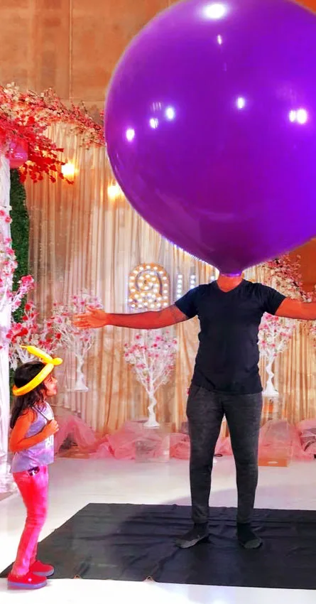 Balloon artist entertaining kids at a birthday party in Chennai with creative balloon animals, colorful designs, and interactive games for children.