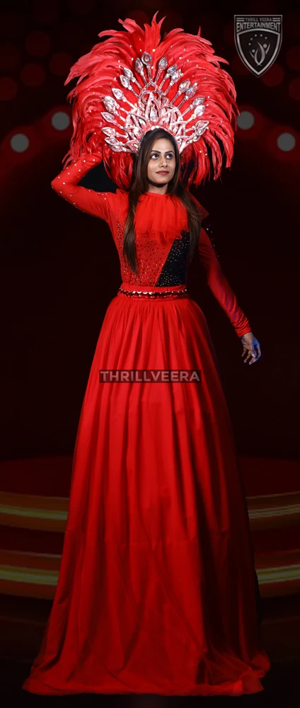 Colorful carnival variety show performance by ThrillVeera Entertainment featuring stilt walkers, clowns, dancers, and festive parade acts