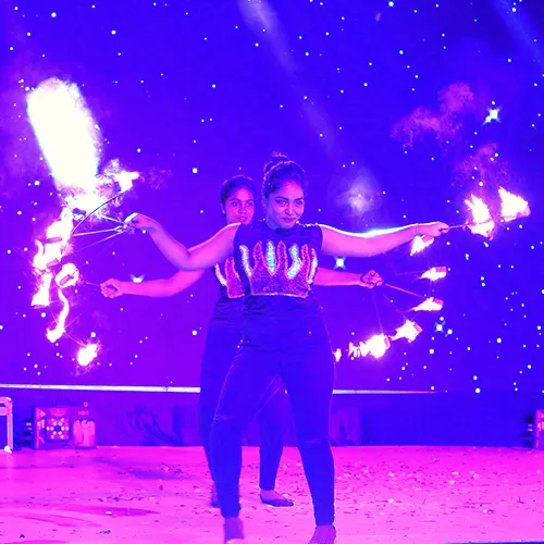 Live performance featuring juggling, fire tricks, and unicycle skills by Thrillveera Entertainment.