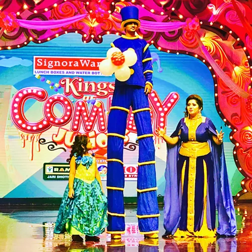 Stilt Walker Act Show by ThrillVeera Entertainment featuring performers in vibrant costumes at a high-energy event or celebration