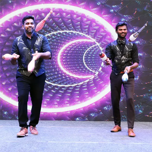 Live performance featuring juggling, fire tricks, and unicycle skills by Thrillveera Entertainment.